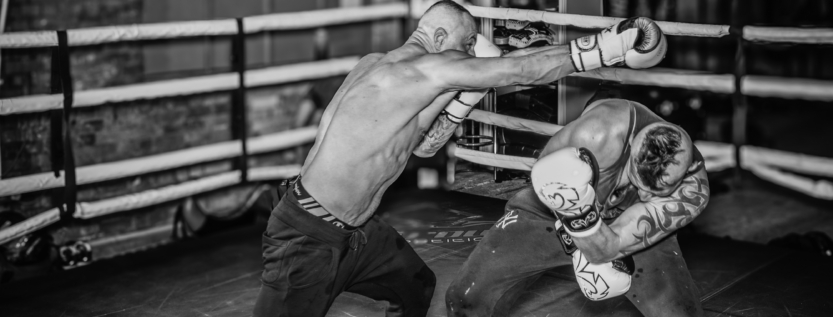 Jasiek’s sparring partner dodging a powerful punch during an intense boxing match.