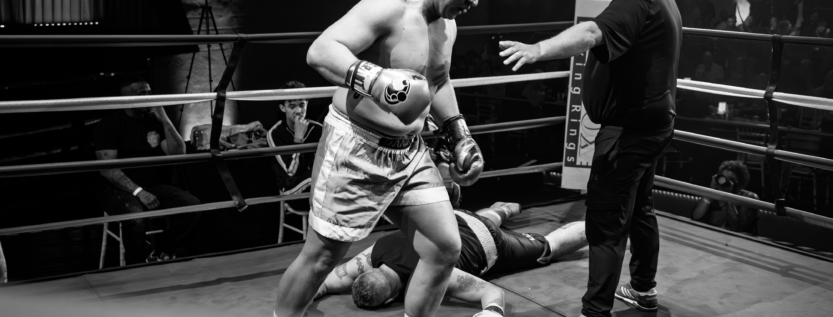 Boxer stands over knocked-out opponent as referee intervenes at Rocky’s Gala, Leicester, March 2025