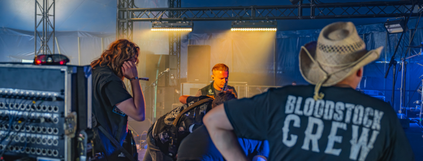 Rascal band members preparing on stage at Bloodstock Open Air 2025 with crew support.