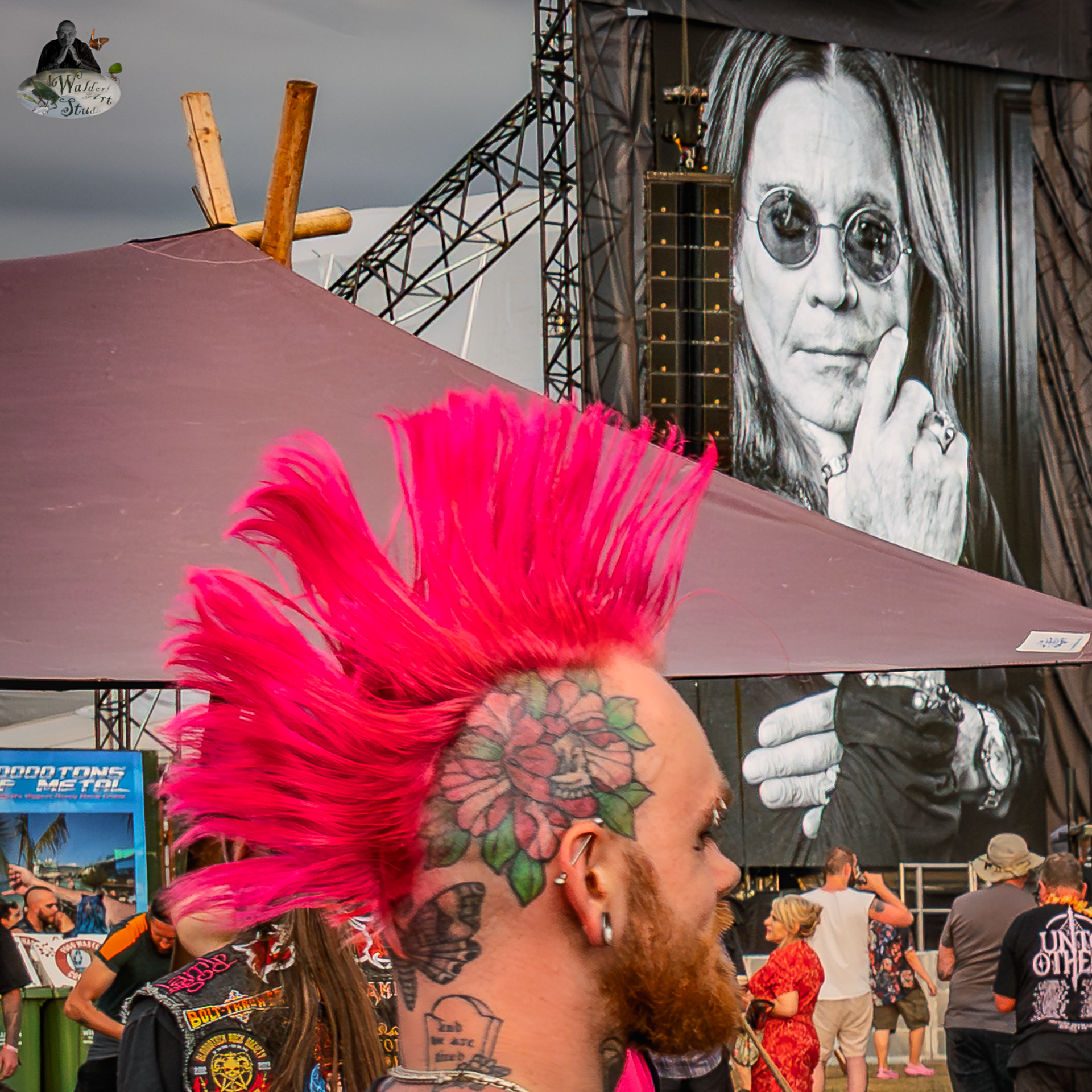 WaldorfArtStudio_2025.08.07 Ozzy Osbourne Tribute and Festival Identity at Bloodstock 2025 Festival-goer with bright pink mohawk in front of Ozzy Osbourne tribute screen at Bloodstock Open Air 2025