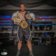 Boxing champion standing in the ring holding multiple ICB title belts after a victorious fight at the Derby Boxing Gala. Captured by Waldorf Art Studio, UK sports photographer.